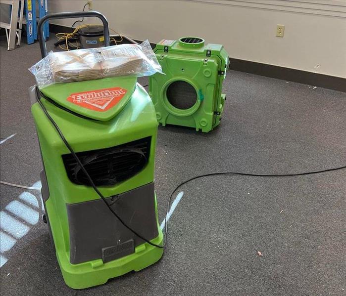 Green drying equipment on floor.